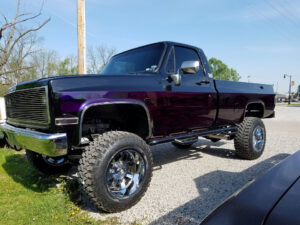 Purple 1977 GMC K20 driver side