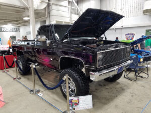 Purple 1977 GMC K20 passenger side