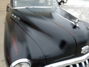 Black classic car curved hood
