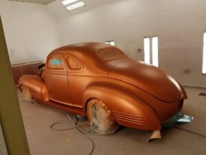 Orange classic car in paint booth