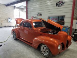 Orange classic car hoods open