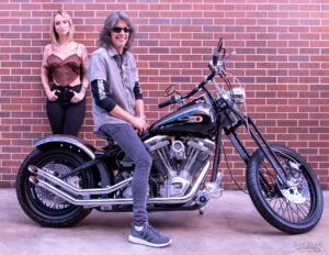 Magazine model with Kelly Hansen of Foreigner on custom Harley Davidson motorcycle