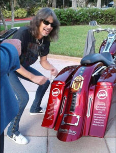 Foreigner's Kelly Hansen with Shriners Childrens' motorcycle at hospital